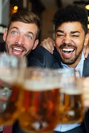 people laughing and drinking at a party